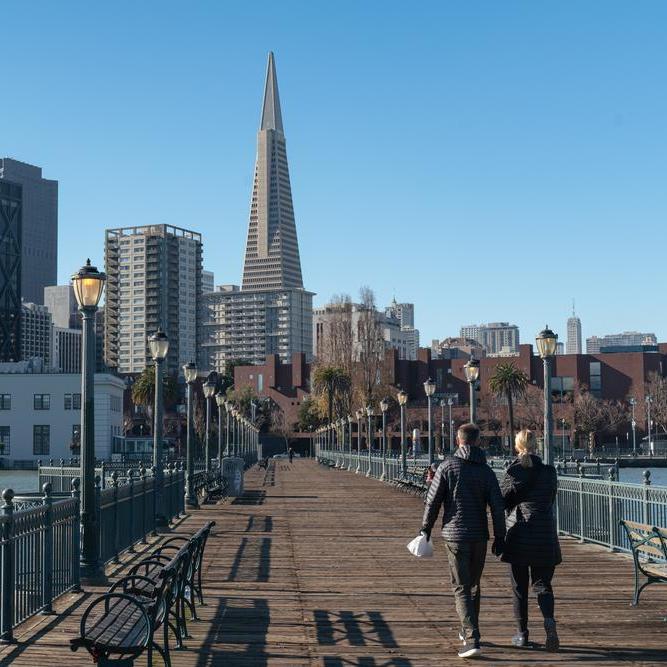 A couple walks along Pier 7