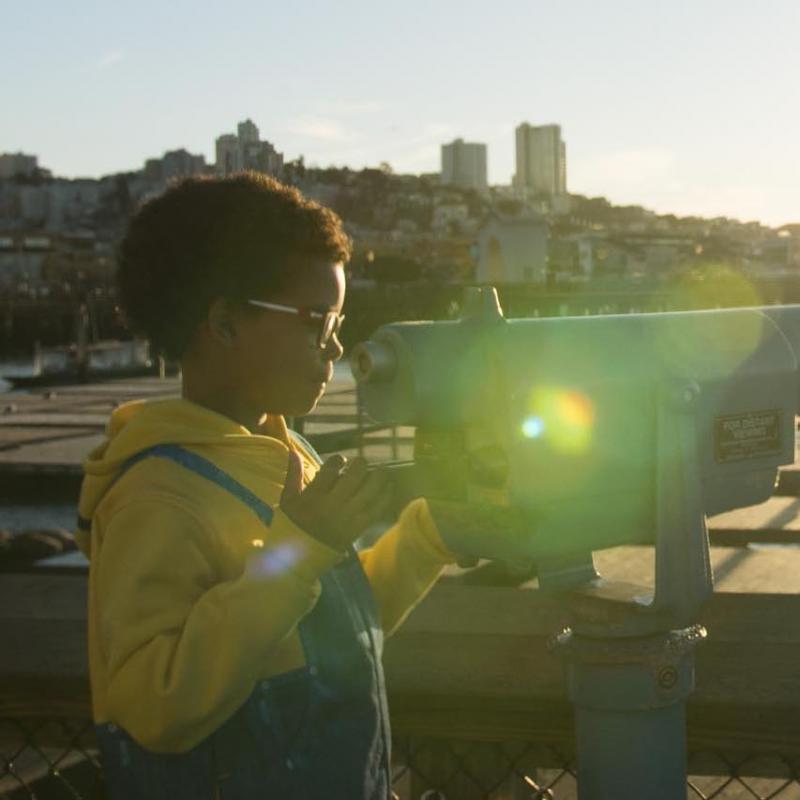 Child with binoculars at Pier 39