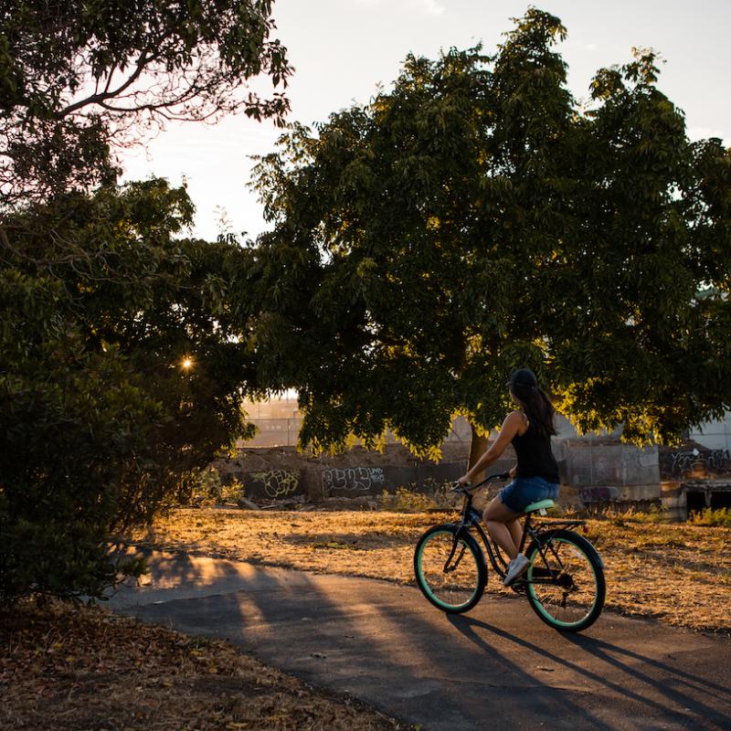 Woman biking at Warm Water Cove